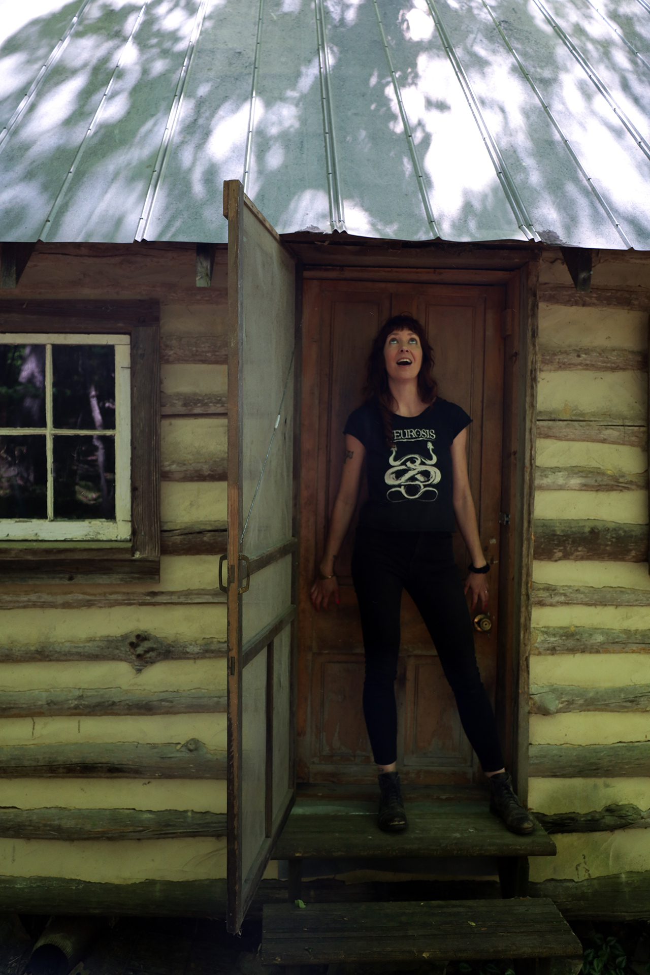Mesha Maren at the door of her writing cabin in West Virginia (photograph by Saja Montague)