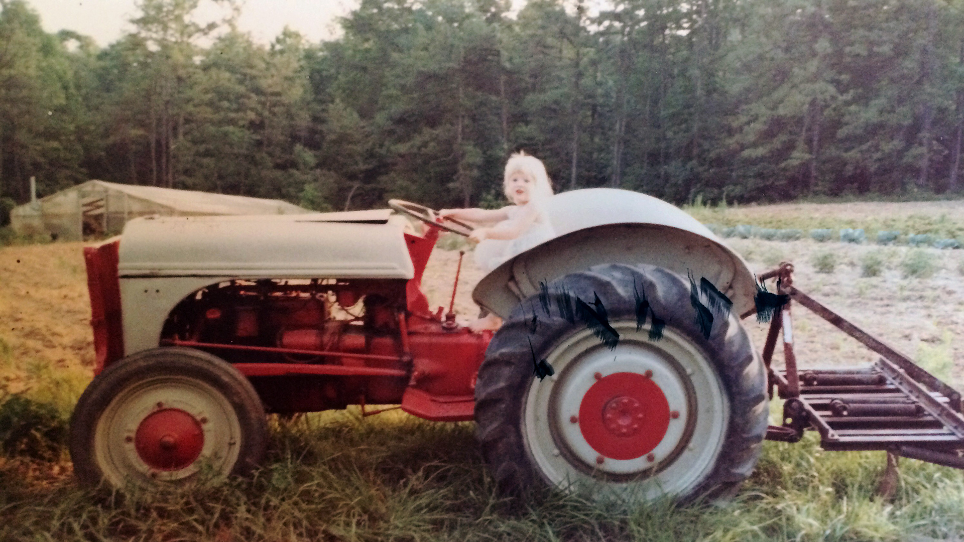 The author, when she was a child, on her grandfather's tractor