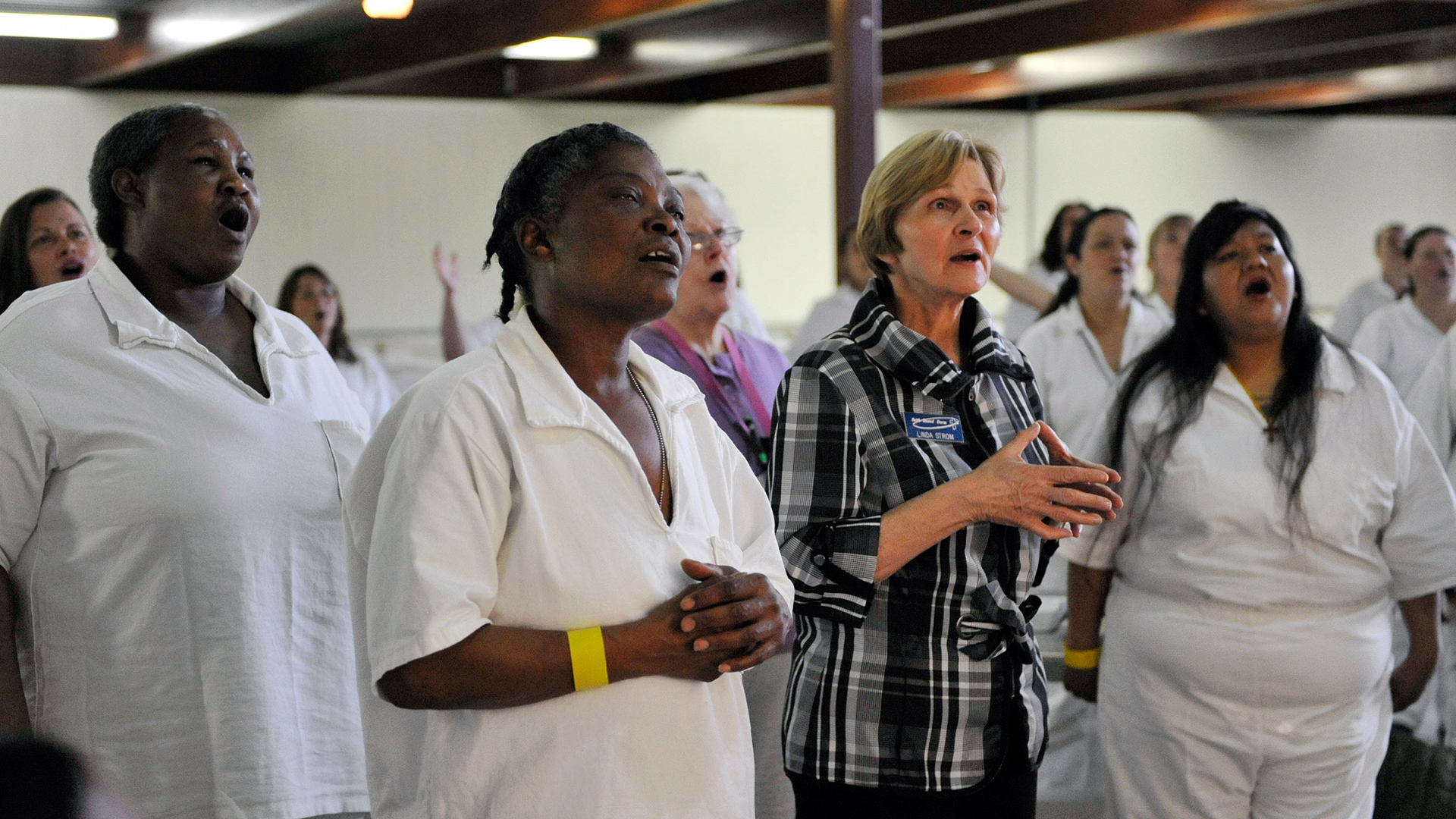 Linda worshipping along with inmates at a chapel service in the Murray Unit.  