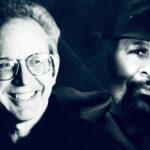 A black and white duotone photograph showing two men in a side-by-side portrait composition. On the left is music historian Peter Guralnick, a smiling man with glasses and light-colored hair, while on the right is soul-music legend William Bell wearing a dark fedora and sporting a neatly trimmed beard, photographed in dramatic lighting that emphasizes his thoughtful expression.