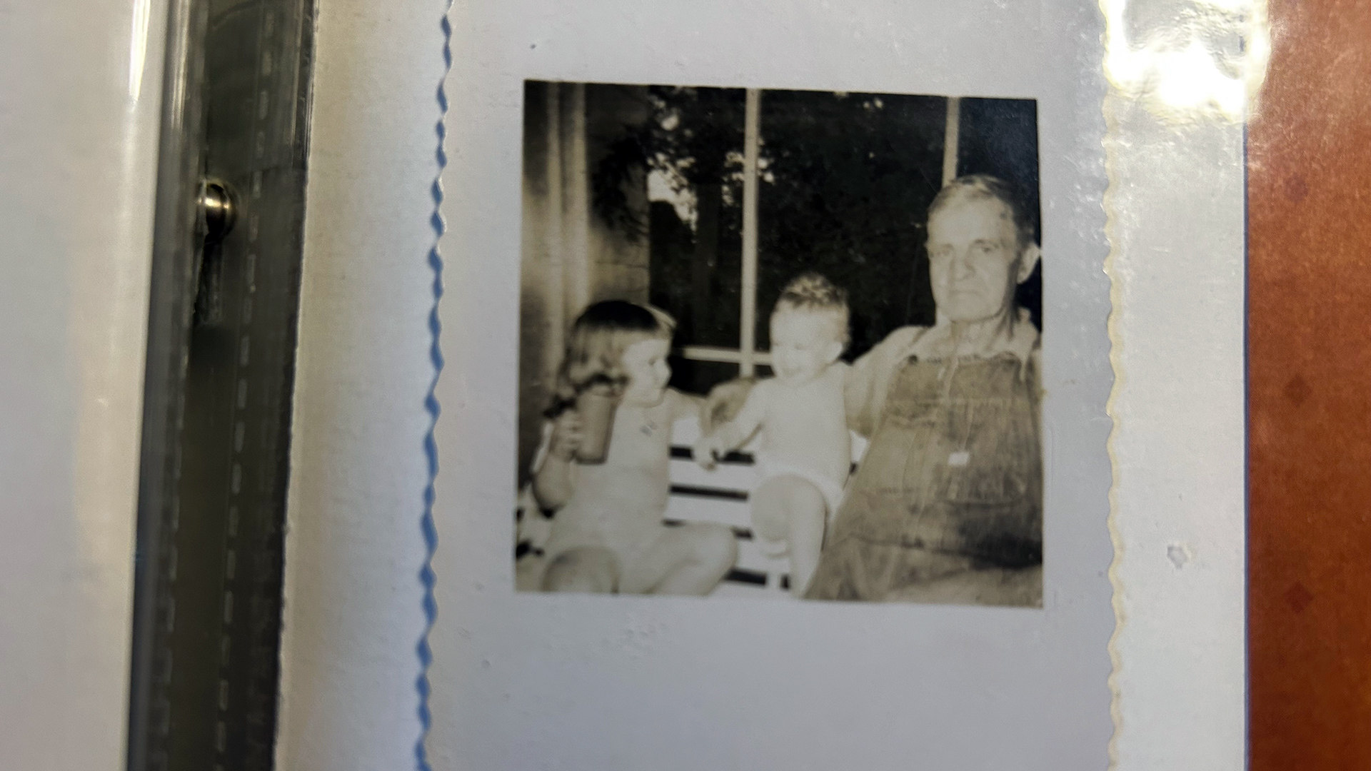 Vintage photo of children sitting with an older man, evoking solastalgia, environmental grief, and childhood memories of rural Georgia as explored by Tracy Thompson