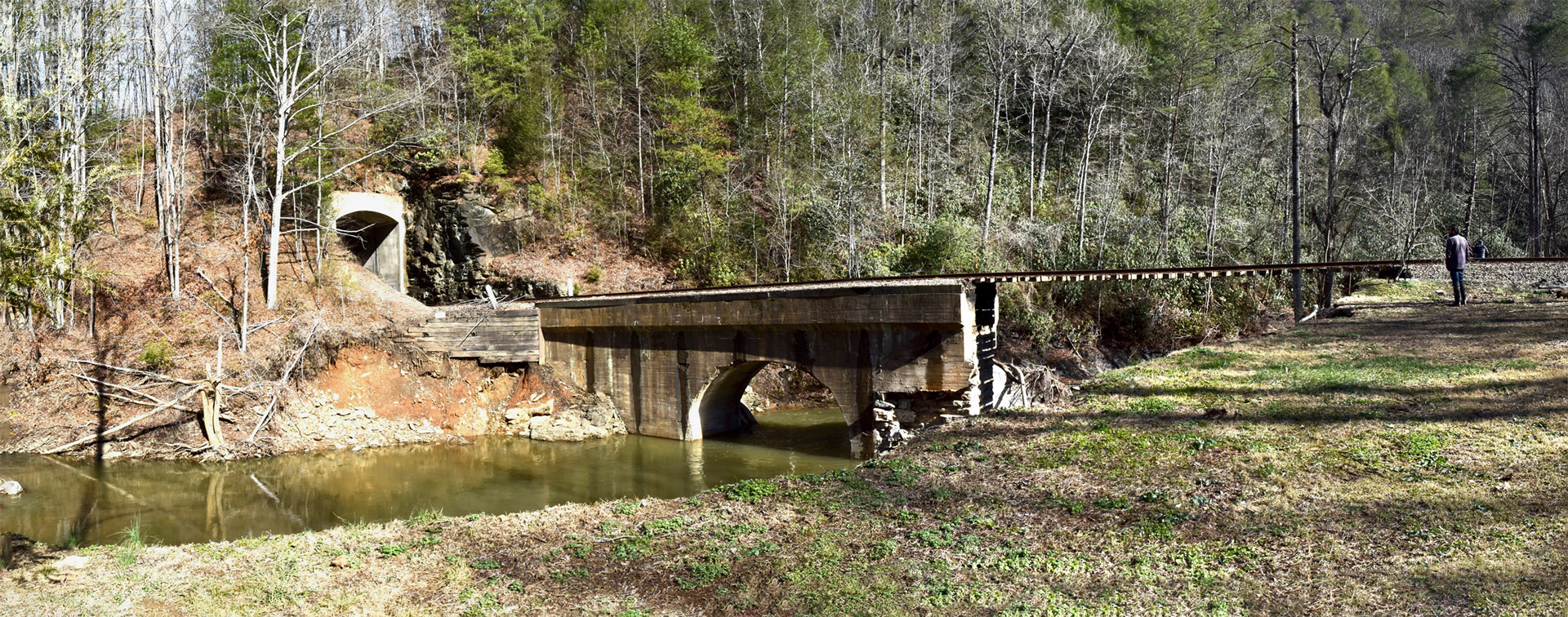 Several miles out of downtown, a railroad tunnel survived, but half the rail bridge over Mill Creek washed away.